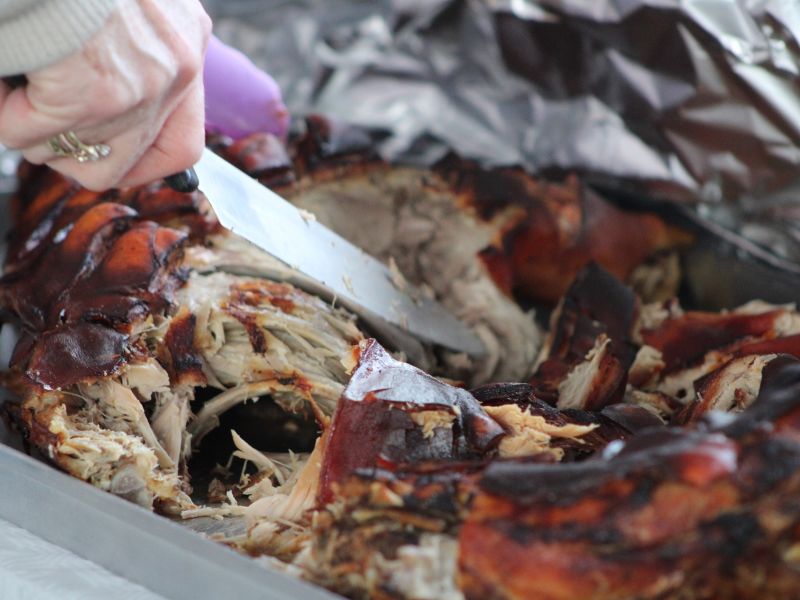 carving a piece of roast pork