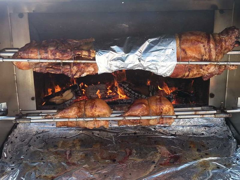 pig on a spit over a wooden fire