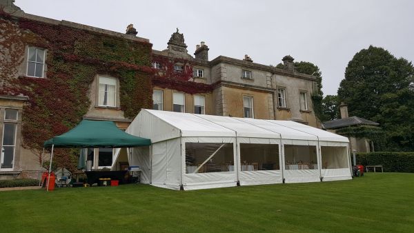 marquee on a lawn outside a country house