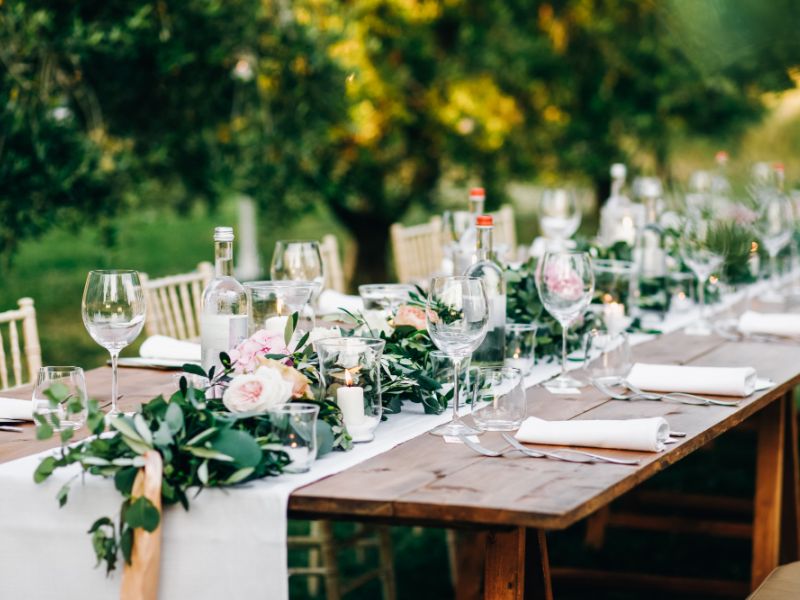 table and chairs with plates, cutlery and glasses