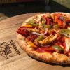 cooked pizza o0n a wooden board